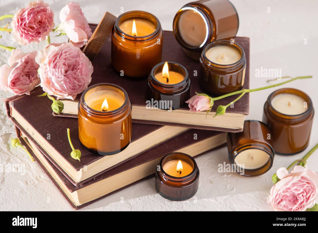 Ein Set verschiedener Duftkerzen in braunen Glasgefäßen. Handgemachte Duftkerze. Sojalkerzen brennen in einem Glas. Aromatherapie und entspannen Sie sich im Spa und zu Hause. Feuer in braunem Glas. Stockfoto