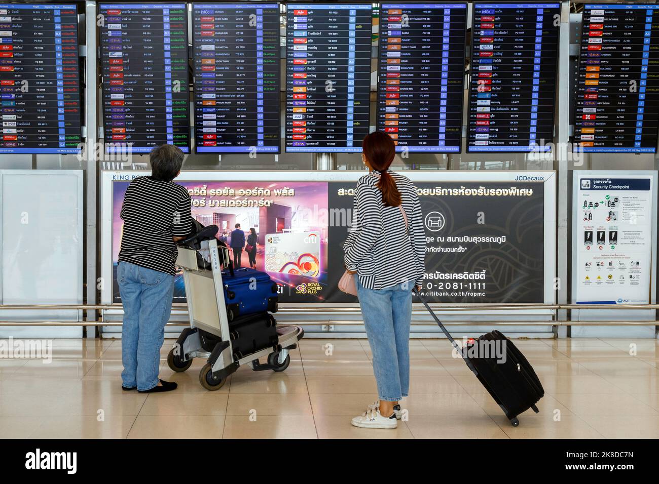 Bangkok, Thailand - 26. Oktober 2022 : Asiatin Passagier mit Gepäck Blick Abreise Zeitplan Bord zum Check-Flug am flughafen suvarnabhumi Stockfoto