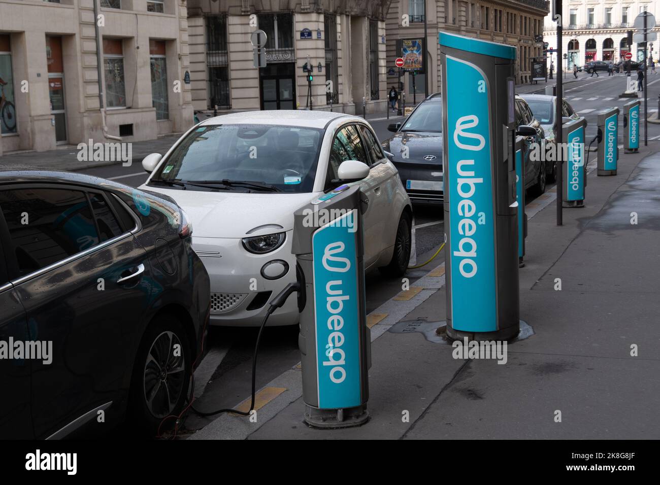 Elektroautos werden an einer Station des Netzwerks Ubeeqo, einem französischen Technologieunternehmen, das gemeinsame Fahrzeugdienstleistungen entwickelt, in Paris, Frankreich, aufgeladen Stockfoto