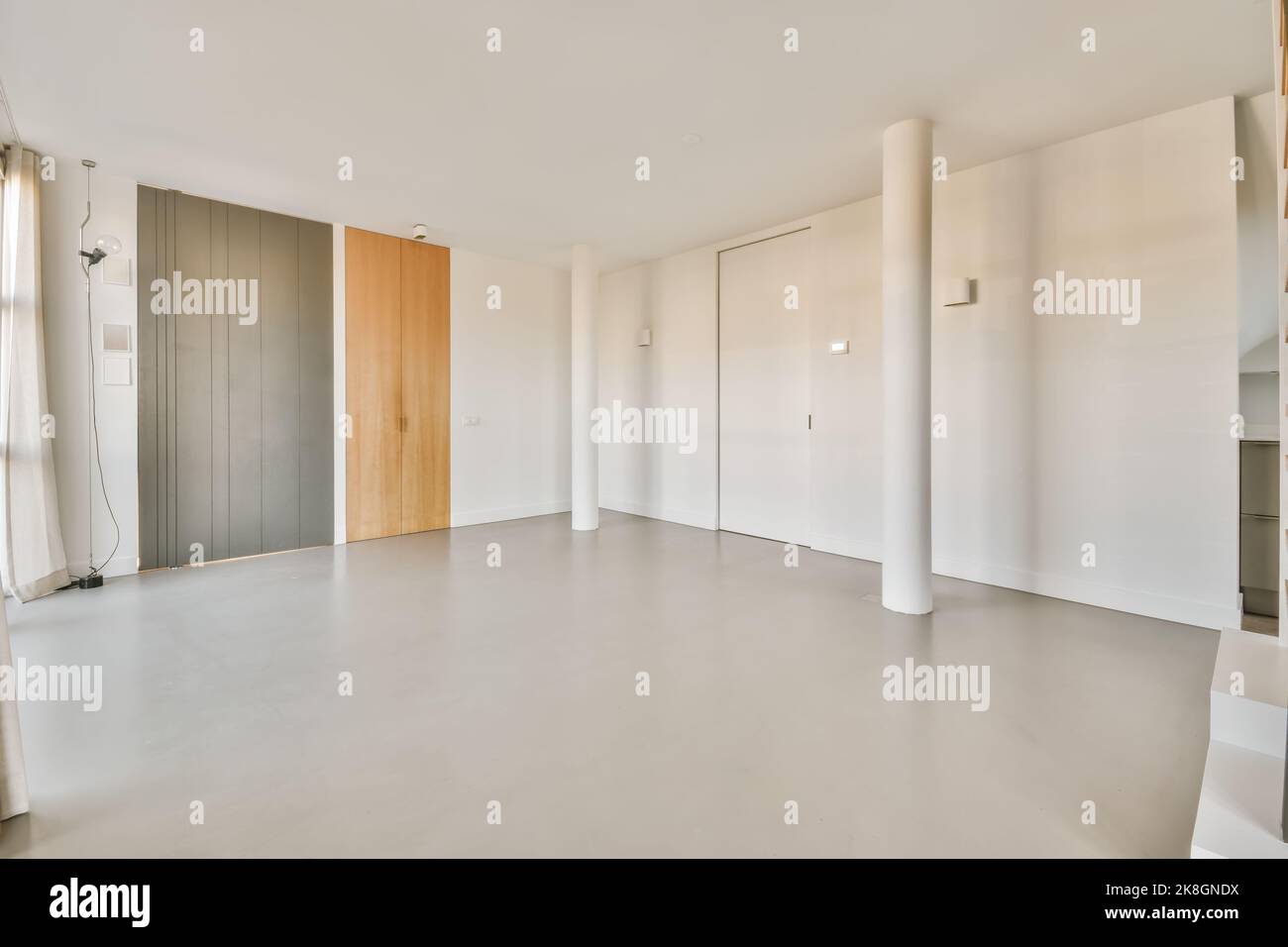 Geräumiges, leeres, unmöbliertes Zimmer im modernen Haus bei Tageslicht Stockfoto