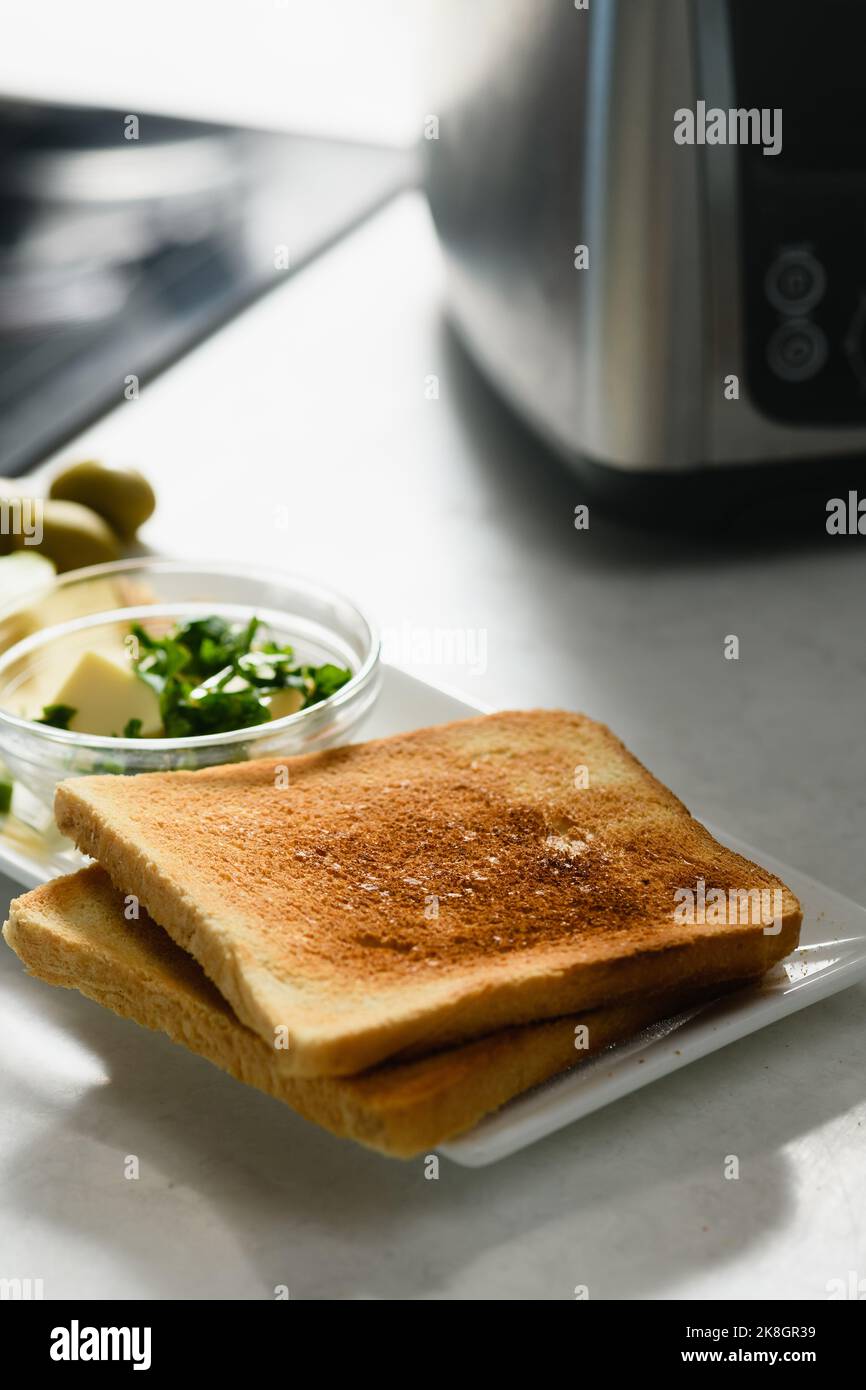 Zwei Toast mit in Scheiben geschnittener Avocado, Butter und Käse für ein gesundes Sandwich. Nahaufnahme. Stockfoto