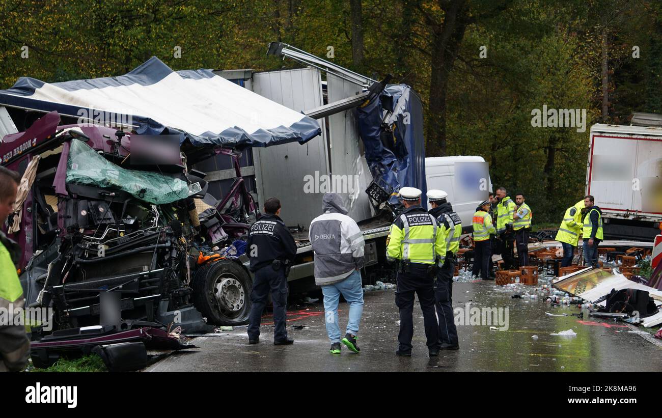 24. Oktober 2022, Baden-Württemberg, Weingarten: Polizeibeamte am Unfallort. Bei einem Unfall auf einer Landstraße in der Nähe von Weingarten (Kreis Ravensburg) ist am Montagmorgen ein Lkw-Fahrer ums Leben gekommen. Nach Angaben der Polizei war der 60-Jährige aus zunächst ungeklärten Gründen in einer Linksabbiegung auf der gegenüberliegenden Fahrspur mit seinem Lkw gekommen und kollidierte mit dem Anhänger eines entgegenkommenden Lkw. Dabei wurde das Fahrerhaus des 60-Jährigen aufgerissen und stark deformiert. (An dpa: LKW-Fahrer stirbt bei Unfall im Kreis Ravensburg) Foto: David Pichler/TNN/dpa - ACHTUNG: Kennzeichen haben Biene Stockfoto