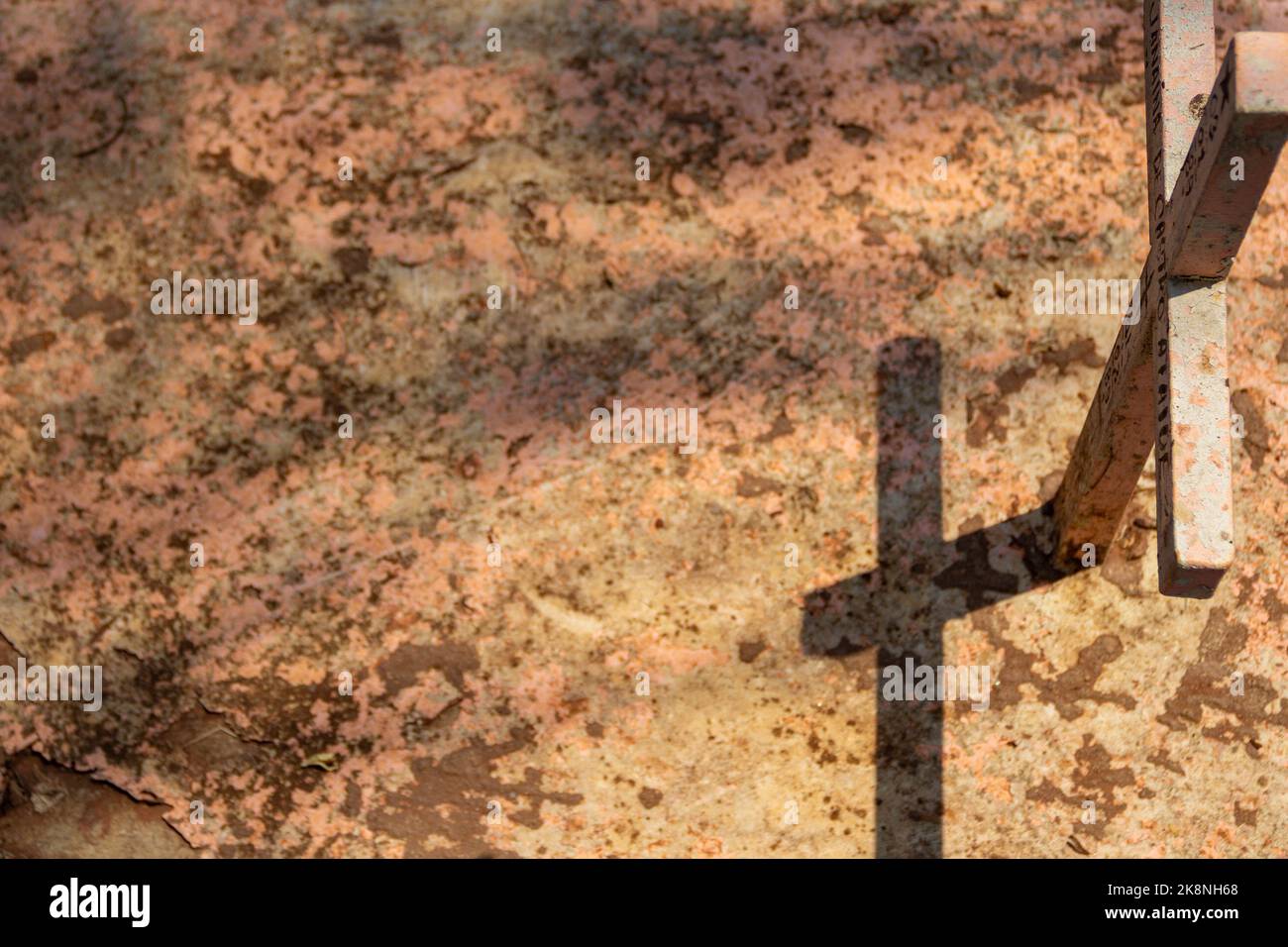 Aparecida de Goiânia, Goias, Brasilien – 23. Oktober 2022:Ein einfaches Kreuz über einem Grab mit seinem Schattenwurf auf einem Friedhof. Stockfoto