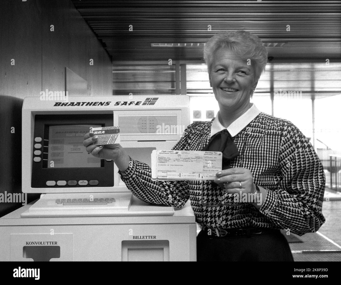 Oslo 19881129 Project Manager Vess Fjeldstad präsentiert den ersten Self-Service-Ticketautomaten, der an einem Flughafen in Norwegen installiert ist. Foto vor der Maschine von Braathens Safe. Sie hält einen Bracard und ein Flugticket. Foto: Holmberg / NTB / NTB Stockfoto