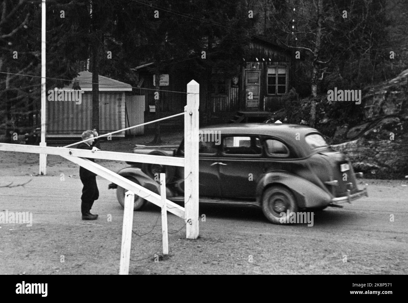 1949 Zollstation Svinesund. Die Zollbehörden des Halden-Zollbezirks kontrollieren die Grenzgänger im Hinblick auf den Schmuggel von Devisen und Textilwaren. Die Zollbeamten befinden sich in einem ehemaligen deutschen Wachraum. Hier lässt einer der Zollbeamten ein Auto durch den Boom fallen. Foto: Sverre A. Børretzen / Aktuell / NTB Stockfoto