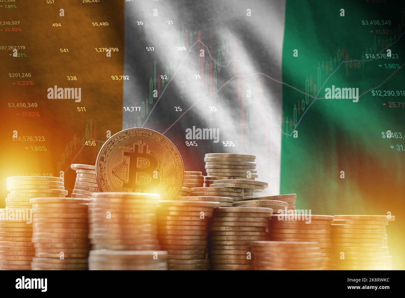 Elfenbeinküste Flagge und große Menge an goldenen Bitcoin-Münzen und Handelsplattform Chart. Krypto-Währungskonzept Stockfoto
