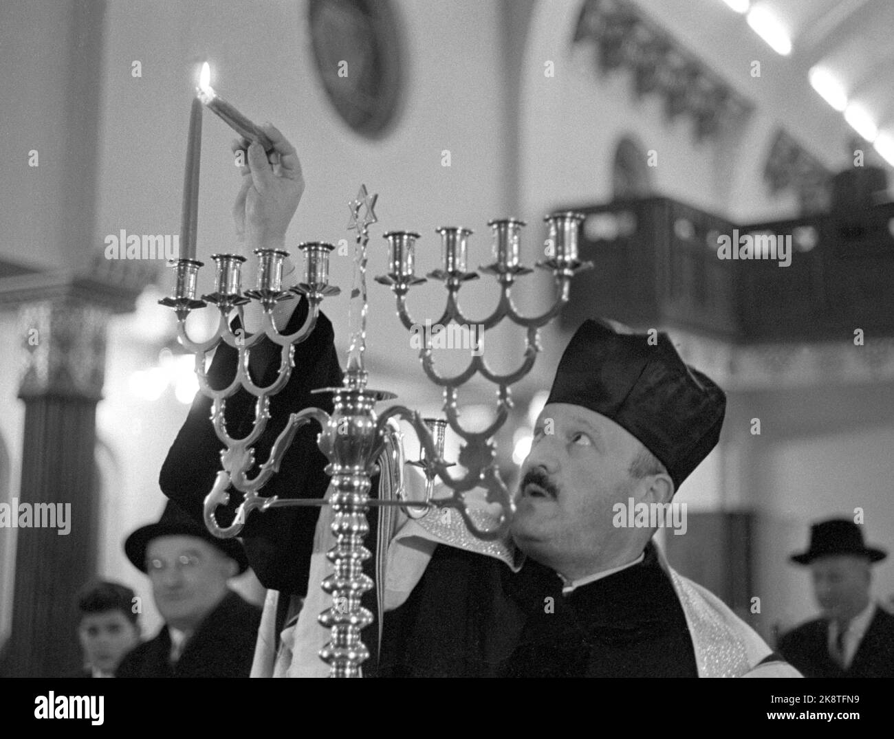 Oslo 19601128 Chanukka dauert bis Ostern. Die Chanukka-Partei hat - die jüdische Lichtpartei begonnen. Acht Tage lang halten die Juden die letzten. Von der Feier in der Synagoge in der mosaischen Religionsgemeinschaft in Oslo. Es ist der Kantor, der während des Dienstes das erste Licht anzündet. Foto: Sverre A. Børretzen / Aktuell / NTB Stockfoto