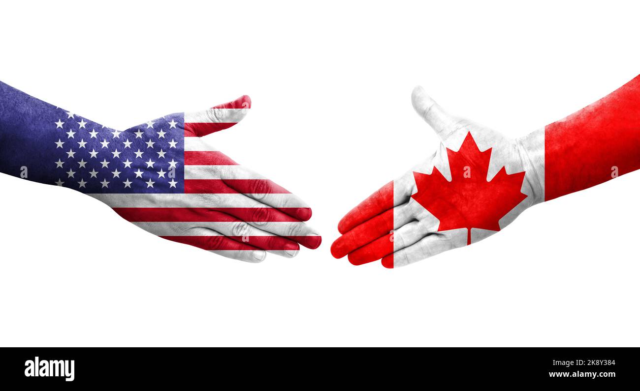 Handschlag zwischen Kanada und USA Flaggen auf Händen gemalt, isolierte transparente Bild. Stockfoto