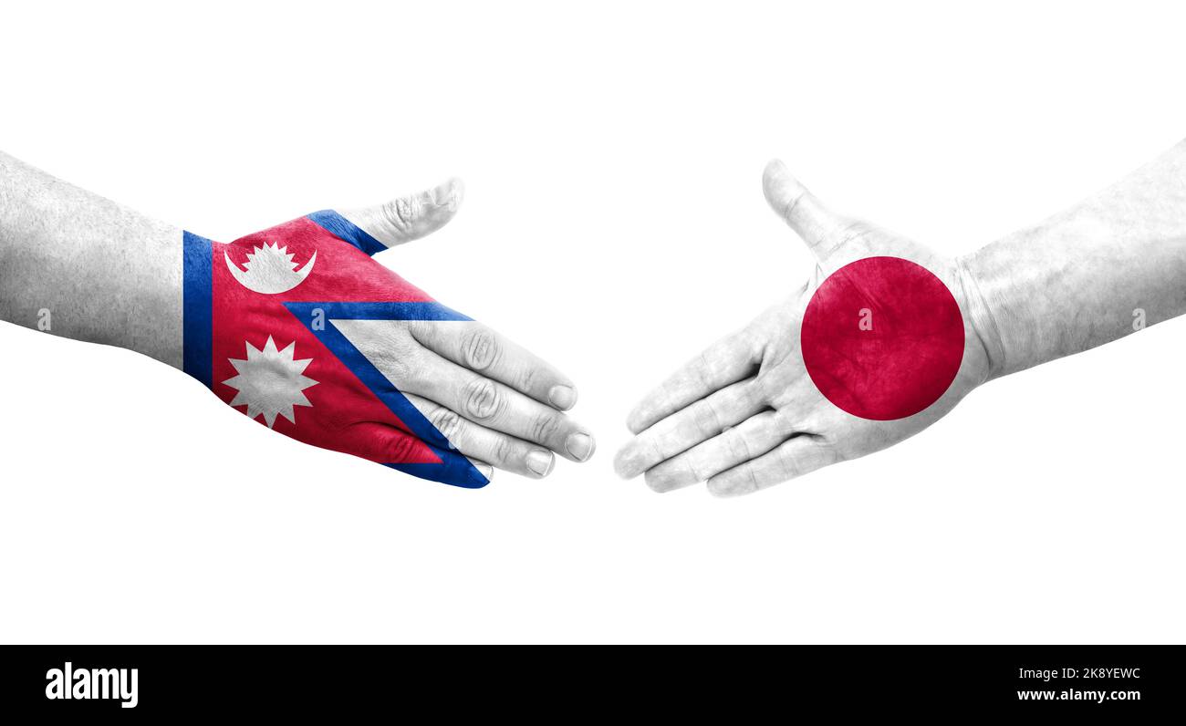 Handschlag zwischen japanischen und nepalesischen Flaggen auf Händen gemalt, isoliertes transparentes Bild. Stockfoto