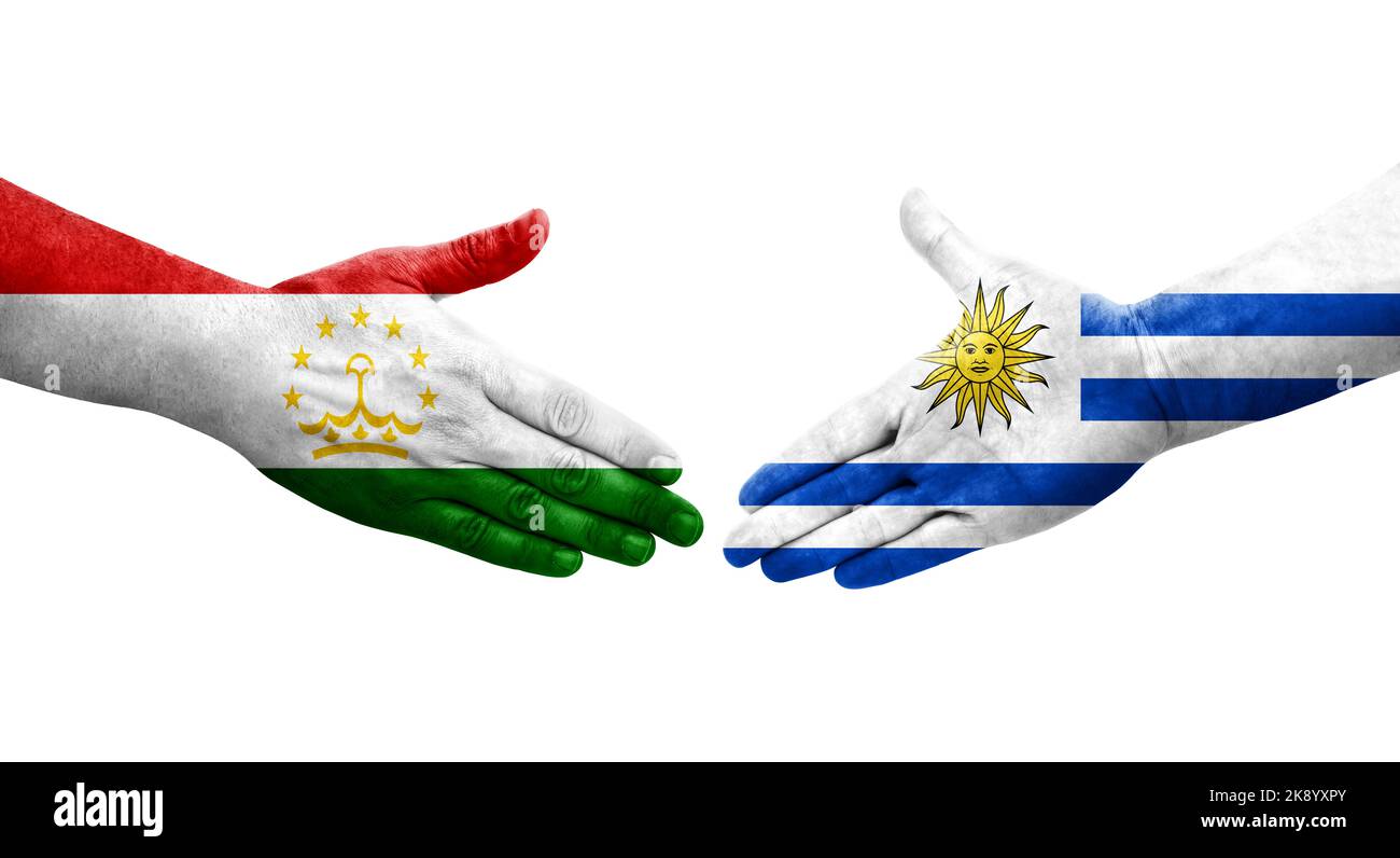 Handschlag zwischen Tadschikistan und Uruguay Flaggen auf Händen gemalt, isolierte transparente Bild. Stockfoto