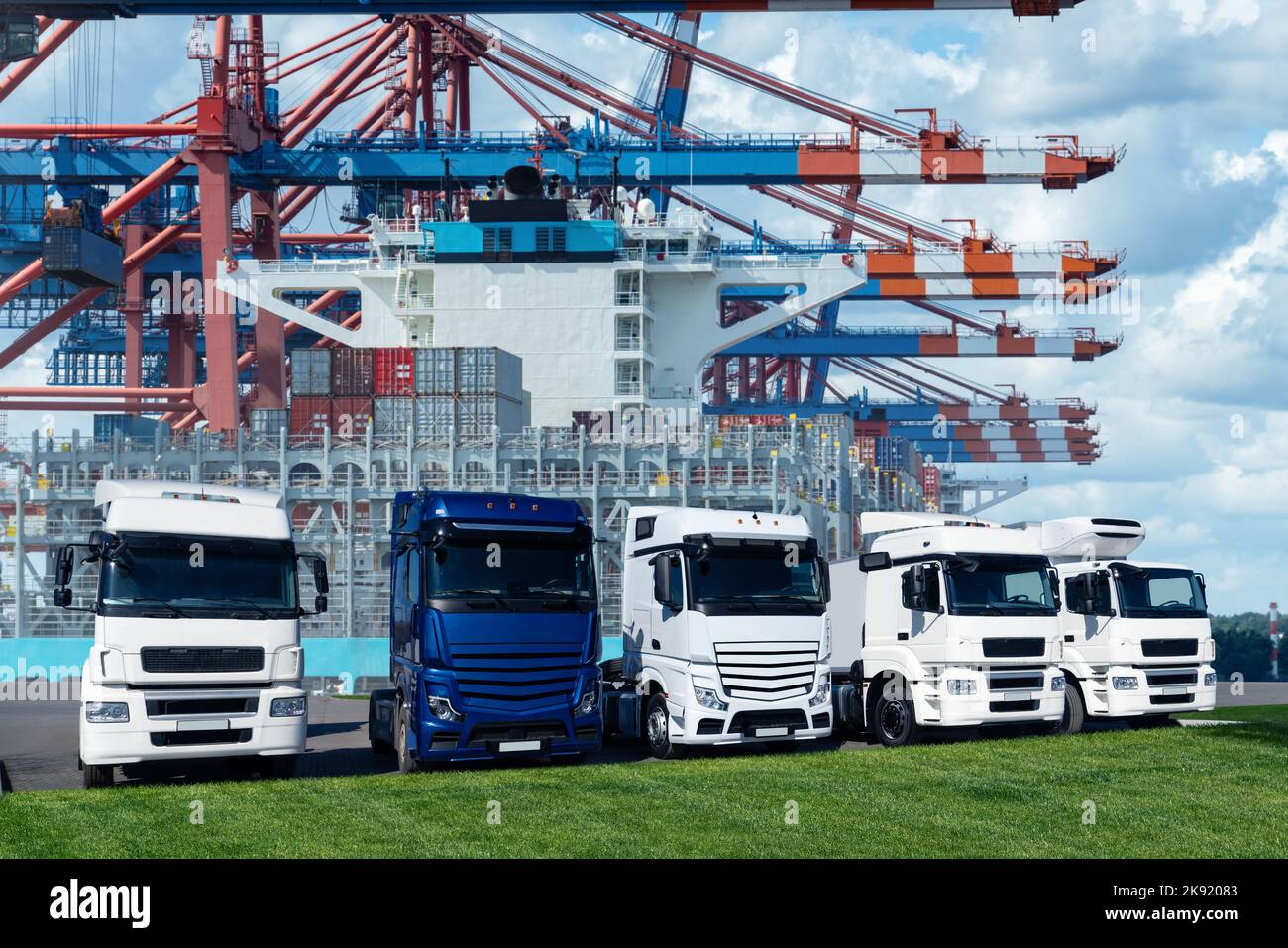 LKW im internationalen Seehafen vor dem Hintergrund eines mit Containern beladenen Schiffes. Internationales Handels- und Logistikkonzept Stockfoto