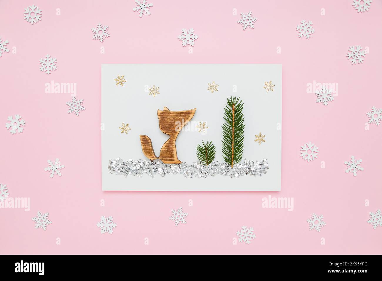 Weihnachten, Silvester Urlaub Komposition. Fuchs im Winterwald auf weißem und pastellrosa flachem Hintergrund mit Schneeflocken. Minimalismus Stockfoto