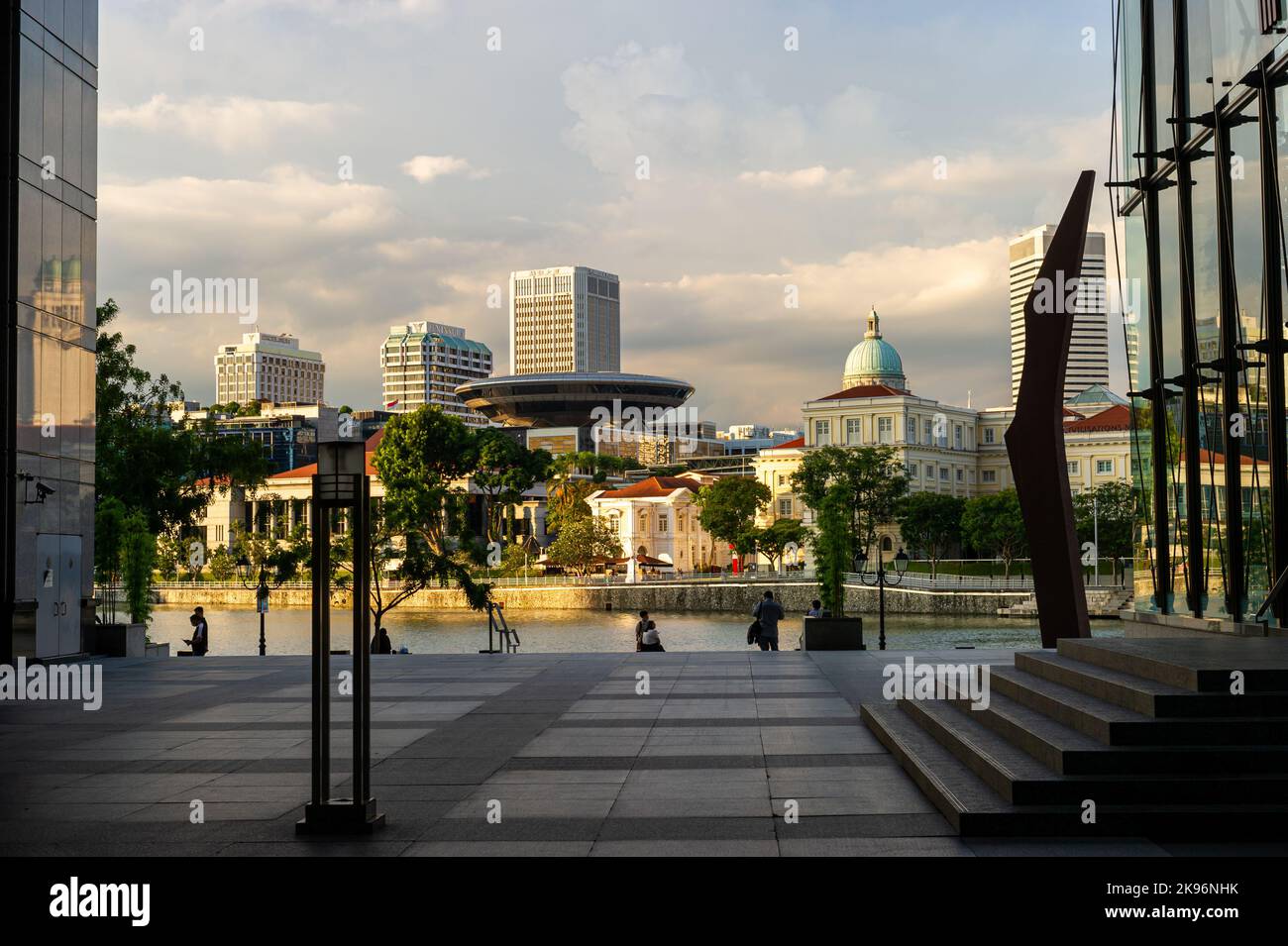 Boat Quay bei Sonnenuntergang, umrahmt von einem Raffles Place Stockfoto