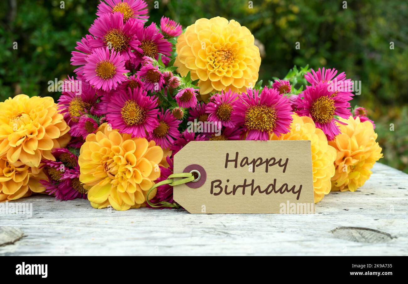 Geburtstagskarte mit einem Blumenstrauß aus Herbstblumen und dem englischen Text: Happy Birthday Stockfoto