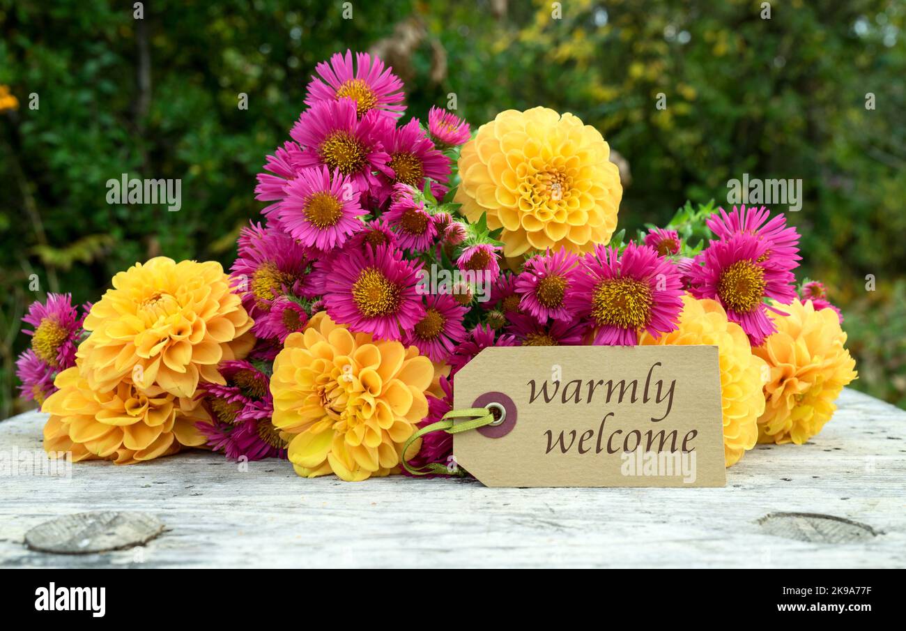 Grußkarte mit einem Blumenstrauß aus Herbstblumen und dem englischen Text: Herzlich willkommen Stockfoto