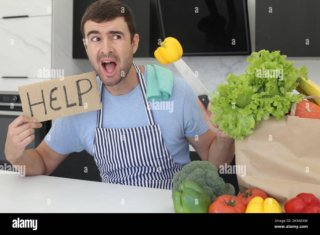 Verwirrt Mann bat um Hilfe in der Küche Stockfoto