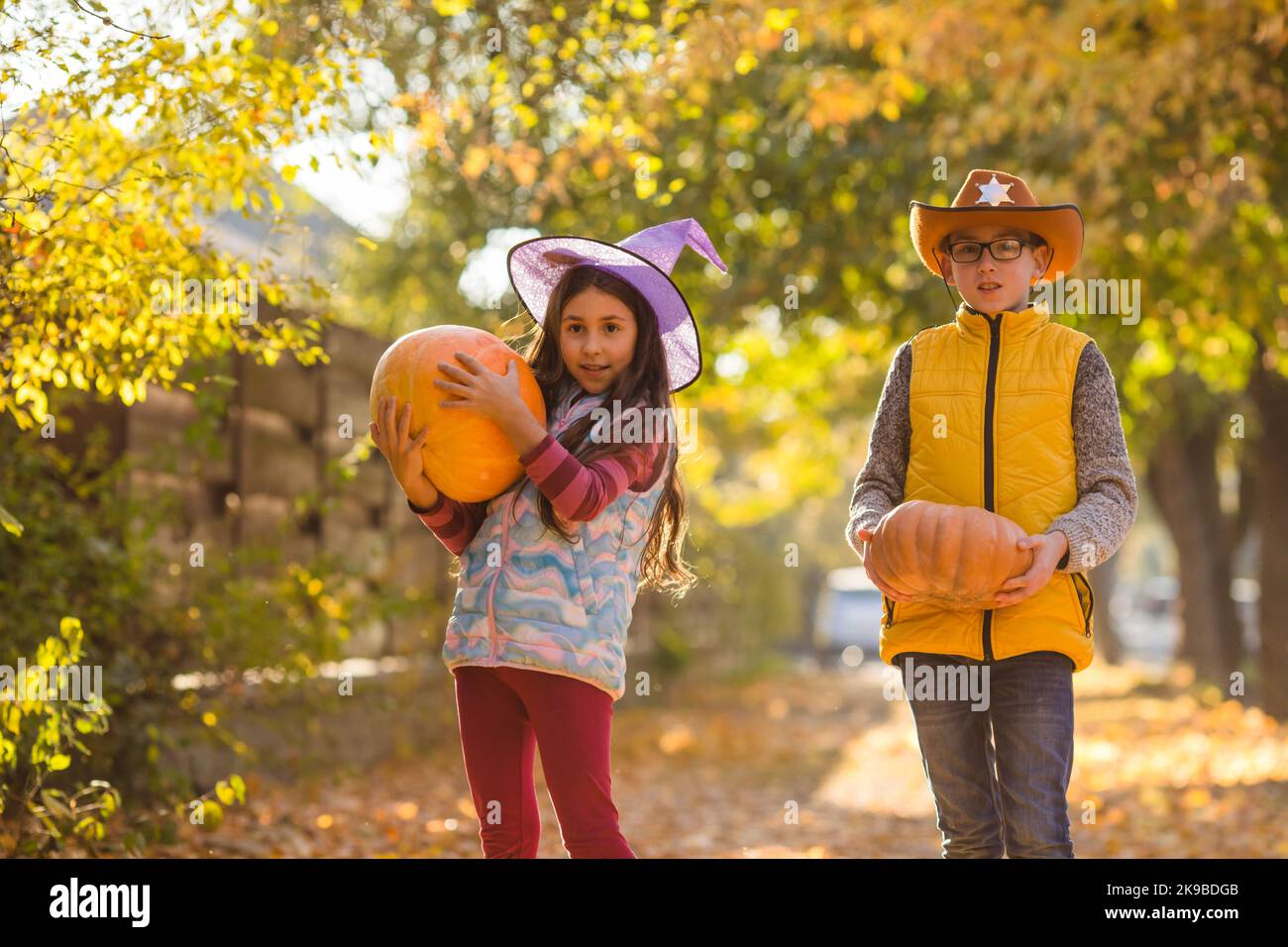 Eine Gruppe von kleinen Kindern genießt das Erntefest auf dem Kürbisfeld Stockfoto