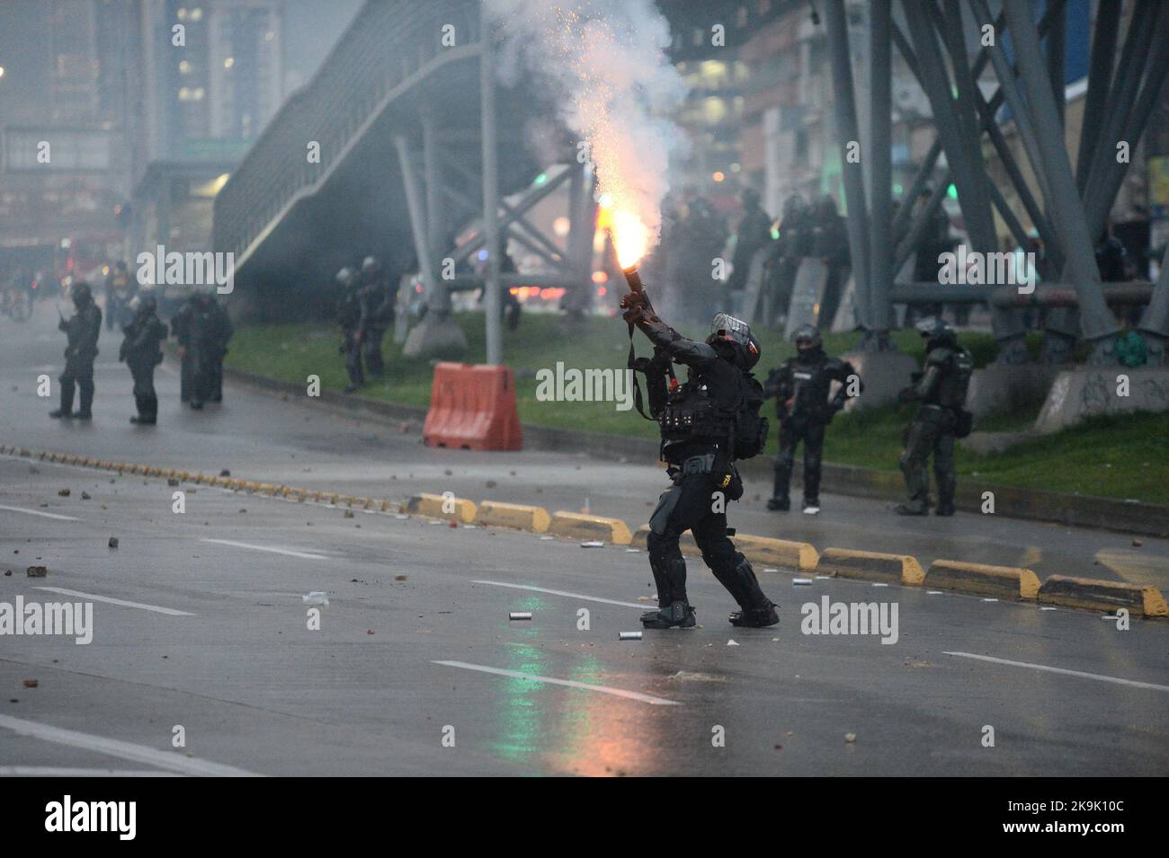 Ein Offizier des kolumbianischen Polizeigeschwaders gegen Unruhen (UNDOMO), der früher geknwon war, als ESMAD eine Tuffly Tränengas-Schrotflinte abfeuert, während die Proteste in Bogota, Kolumbien, während der Befreiung politischer Prisoniere, die während der regierungsfeindlichen Proteste des letzten Jahres am 28. Oktober 2022 gefangen genommen wurden, zunehmen. Foto: Lina Gasca Martin/Long Visual Press Stockfoto