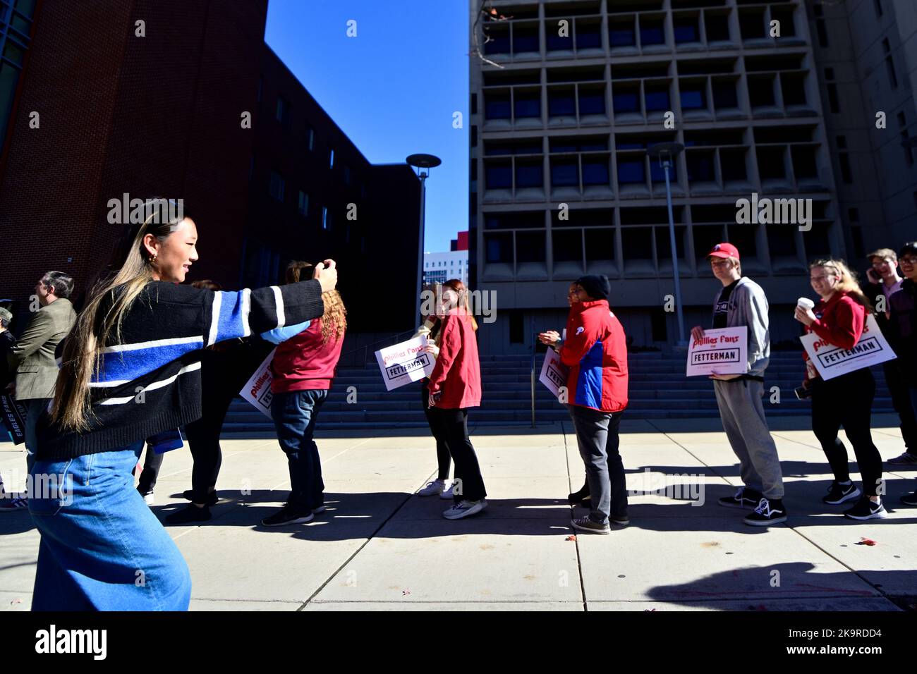 Annie Wu Henry, Social-Media-Managerin der Kampagne, nimmt auf einem Mobiltelefon ein Video von Unterstützern auf, die vor einer Kundgebung mit John Fetterman an der Temple University in North Philadelphia, Pennsylvania, USA, am 29. Oktober 2022 in der Schlange stehen. Kredit: OOgImages/Alamy Live News Stockfoto