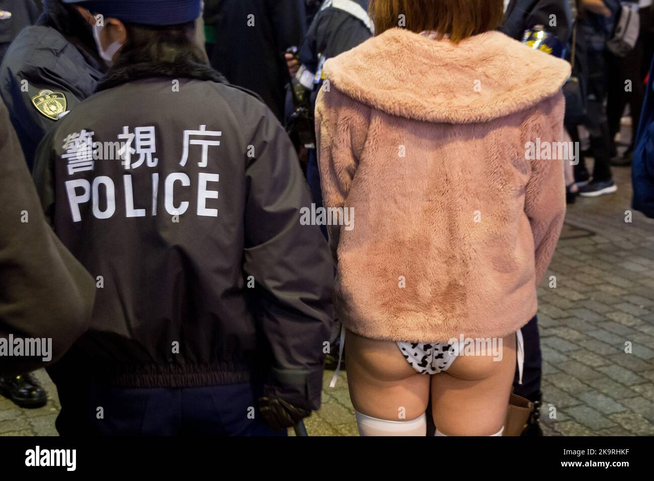 Tokio, Japan. 29. Oktober 2022. Die Polizei eskortiert eine Frau aus der Menge, weil sie unanständig ausgesetzt ist, während die Menschen Halloween im Shibuya Center Gai genießen. Nach einigen Jahren des Coronavirus und der Einschränkung des antisozialen Verhaltens scheinen die berühmten Shibuya Halloween Feiern etwas von ihrer Energie zurückzugewinnen, obwohl eine starke Polizei- und Sicherheitspräsenz und Alkoholverbote auf der Straße verwendet werden, um die Exzesse früherer Ereignisse einzudämmen. Kredit: SOPA Images Limited/Alamy Live Nachrichten Stockfoto