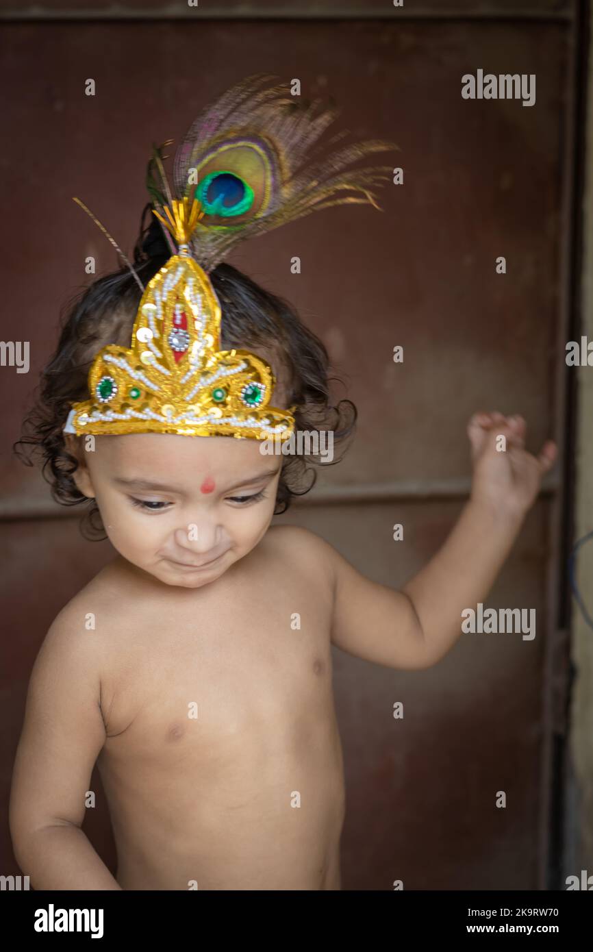 Baby Junge niedlich Gesichtsausdruck in krishna aus einzigartiger Perspektive gekleidet Stockfoto