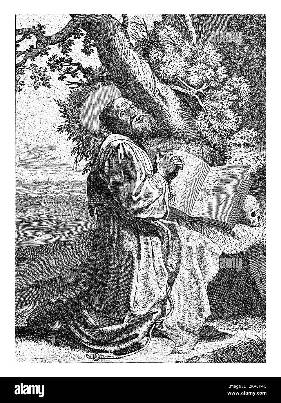 Der heilige Franziskus kniete mit gefalteten Händen in einer Landschaft, vor ihm ein offenes Buch, das auf einem Schädel ruht. Stockfoto