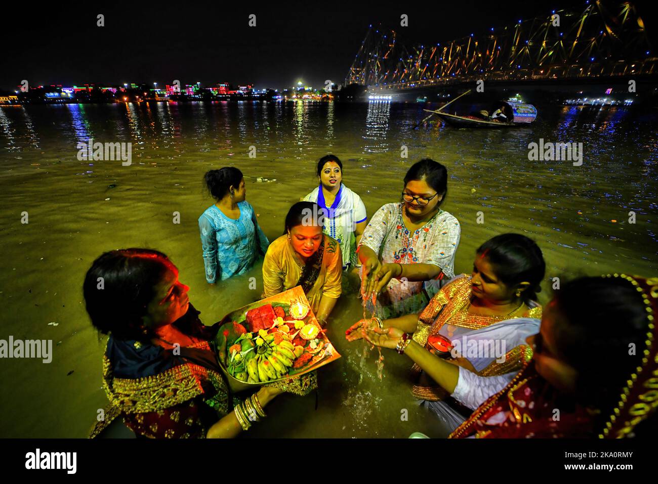Kalkutta, Indien. 30. Oktober 2022. Hinduistische Anhänger werden gesehen, wie sie Abendrituale anlässlich der Chhat Puja im Ganga River durchführen. Chhath ist ein hinduistisches Fest, bei dem der Sonne Gebete gewidmet werden, um Dankbarkeit und Dankbarkeit für die Überwindung der Hürden des Lebens während des ganzen Jahres zu zeigen. Den ganzen Tag fasten Hindu-Anhänger suchen nach dem Segen der Lord Sun gemäß der hinduistischen Mythologie. Da das Festival der Sonne gewidmet ist, findet es jedes Jahr während der Sonnenaufgang und -Untergang Ende Oktober/Mitte November statt. (Foto: Avishek das/SOPA Images/Sipa USA) Quelle: SIPA USA/Alamy Live News Stockfoto