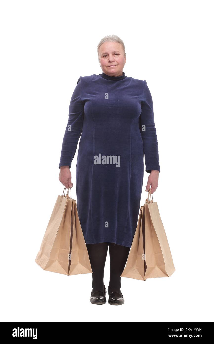 Reife Frau hält Taschen lächelnd und Blick auf die Kamera Stockfoto