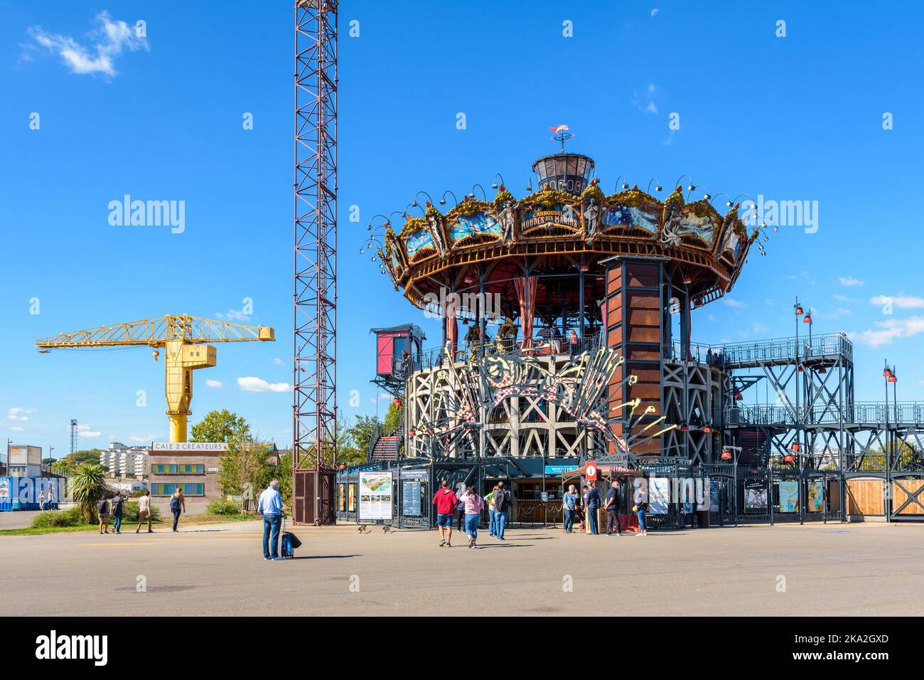 Das Marine Worlds Carousel ist Teil der Maschinen der Touristenattraktion der Insel Nantes, wobei der gelbe Titan-Kran in der Ferne zu sehen ist. Stockfoto