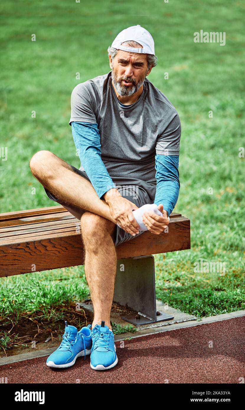Outdoor Senior Fitness Mann Lifestyle aktiv Sport Übung Verletzung Schmerzen Schmerzen Bein Knieangel Stockfoto