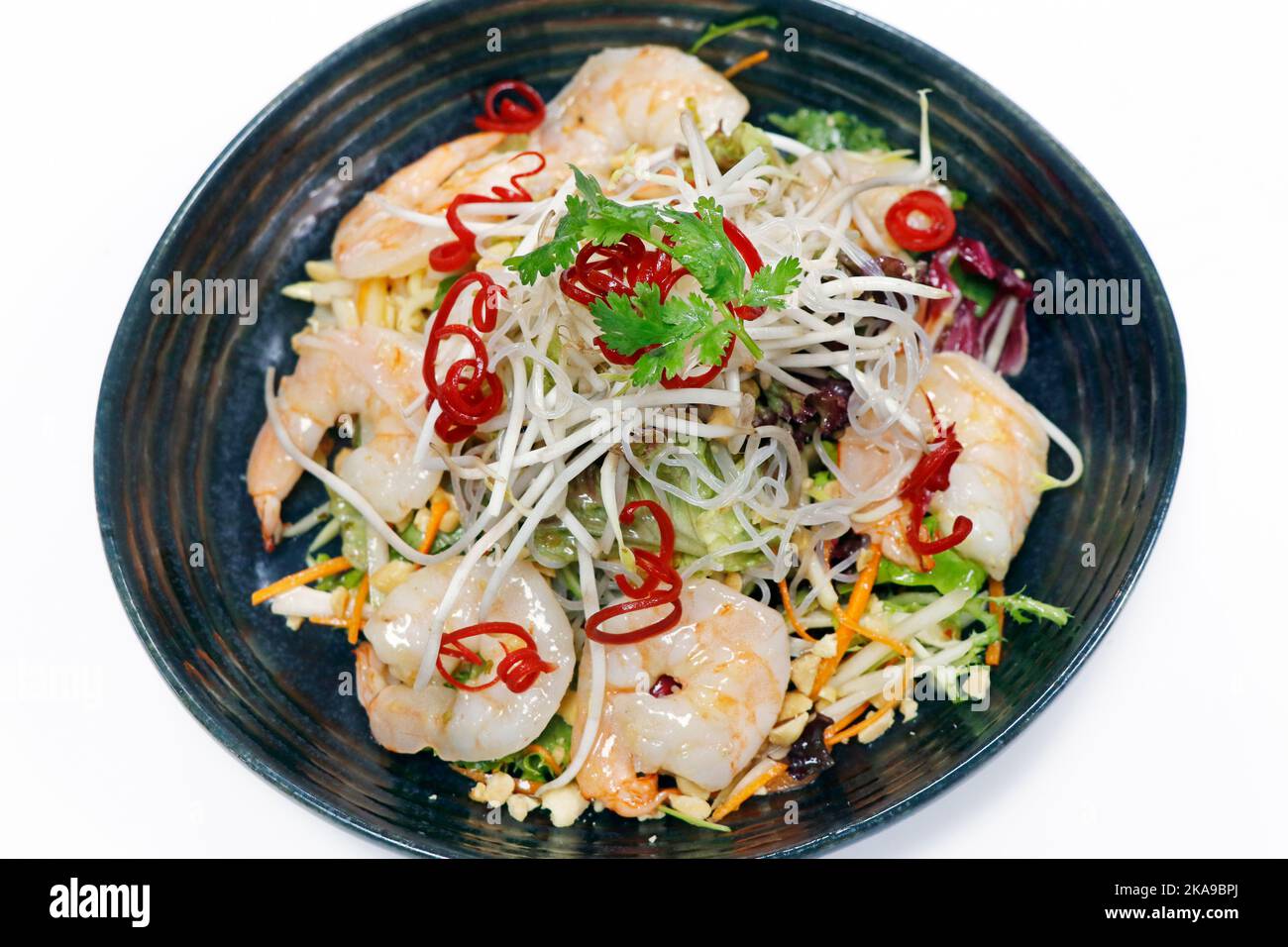 thailändischer, würziger Shrimp-Salat mit knackigem Gemüse, Erdnüssen und Bohnensprossen auf weißem Hintergrund, Draufsicht Stockfoto