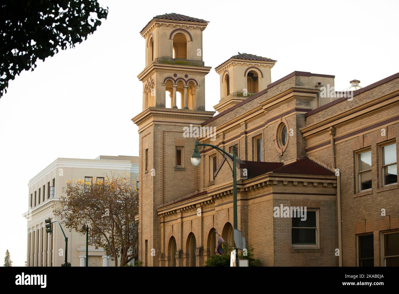 Am späten Nachmittag scheint die Sonne auf der historischen Kirche und der Innenstadt der Bay Area City von Alameda, Kalifornien, USA. Stockfoto