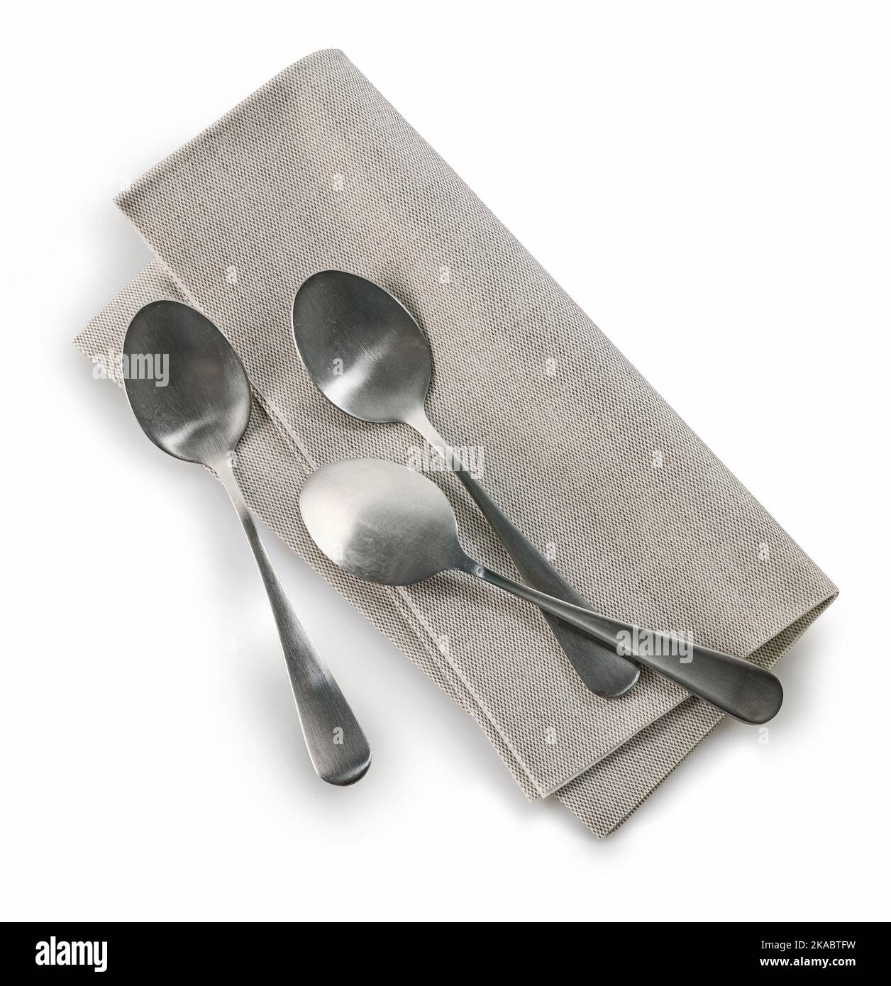 Teelöffel und Serviette isoliert auf Weiß Stockfoto