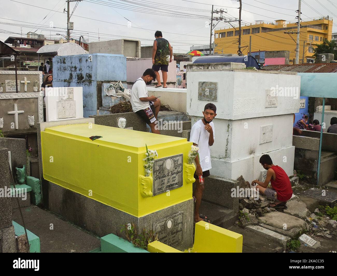 Caloocan City, Philippinen. 01.. November 2022. Die Besucher des Friedhofs verbringen während Allerheiligen Zeit in den Gräbern ihrer Lieben. Filipinos strömen nach zwei Jahren der Covid-19-Pandemie auf Friedhofs, da sich die Einschränkungen langsam lockern. Die Tradition, Blumen zu bringen, Kerzen anzuzünden und sogar Nahrung an der Begräbnisstätte ihrer verstorbenen Lieben anzubieten. Kredit: SOPA Images Limited/Alamy Live Nachrichten Stockfoto