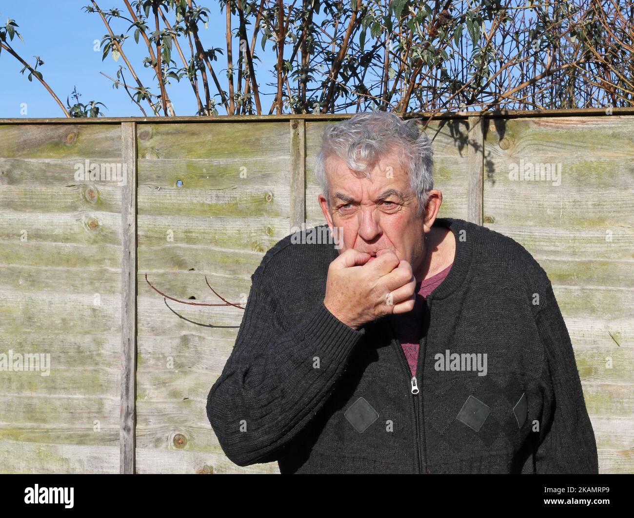 Älterer Mann Finger im Mund pfeifend. Aufmerksamkeit oder Signal zu starten oder zu stoppen. Stockfoto