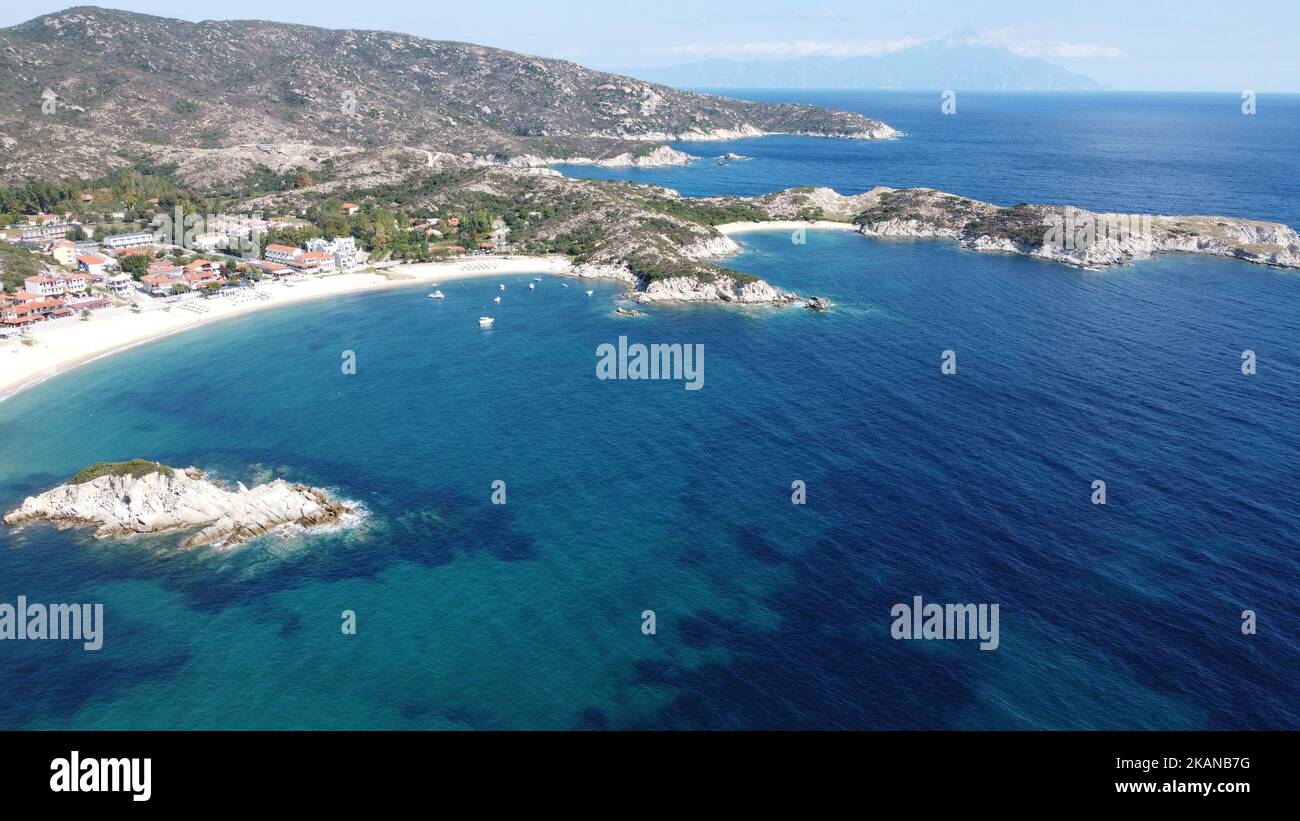 Eine Drohnenaufnahme des Strandes von Kalamitsi mit blauem Wasser und Berg in Griekenland Stockfoto