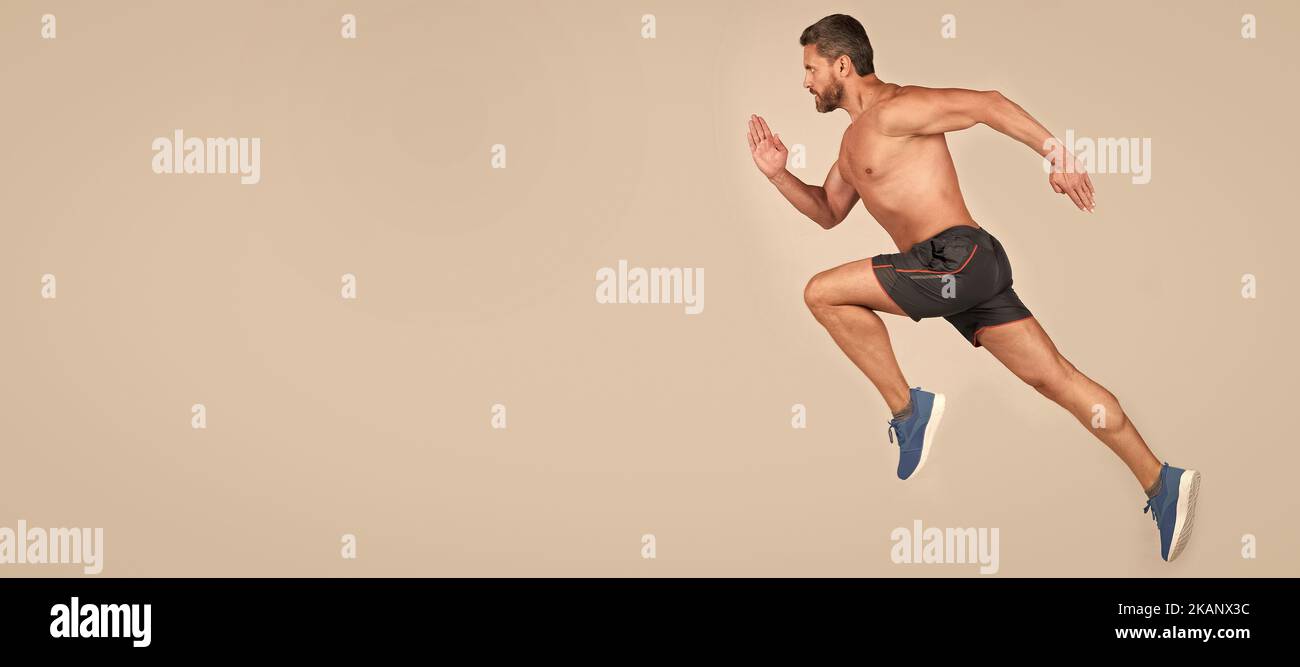 Mann laufen und springen, Banner mit Kopierraum. Sportler Mann Läufer laufen zum Erfolg oder springen hoch auf grauem Hintergrund, Copy Space, Sport. Stockfoto