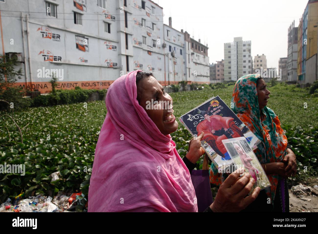 Angehörige eines Opfers aus Bangladesch, das beim Einsturz des Rana Plaza-Gebäudes getötet wurde, trauern, als sie und andere am 24. April 2018 vor dem Gebäude in Savar, am Stadtrand von Dhaka, den fünften Jahrestag der Katastrophe begehen. (Foto von Mehedi Hasan/NurPhoto) Stockfoto