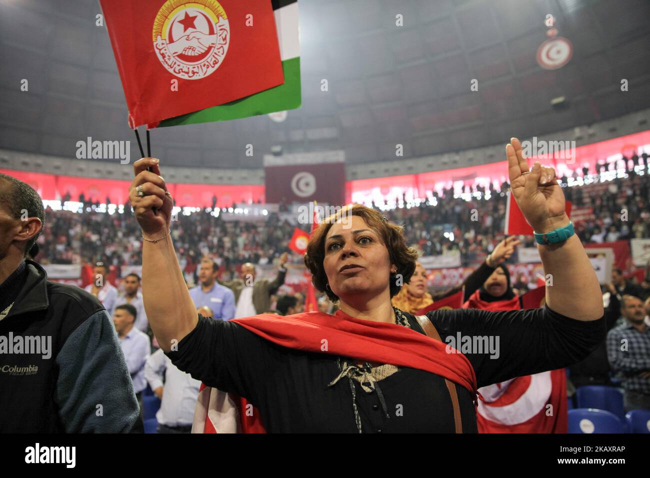 Eine Tunesierin, die die UGTT-Flagge hält, macht das Siegeszeichen, als sie an einer Volkskundgebung der Tunesischen Allgemeinen Arbeitsunion (UGTT) teilnimmt, die am 1. Mai 2018 in Tunis den Internationalen Arbeitertag, auch bekannt als Arbeitertag, feiert. (Foto von Chedly Ben Ibrahim/NurPhoto) Stockfoto