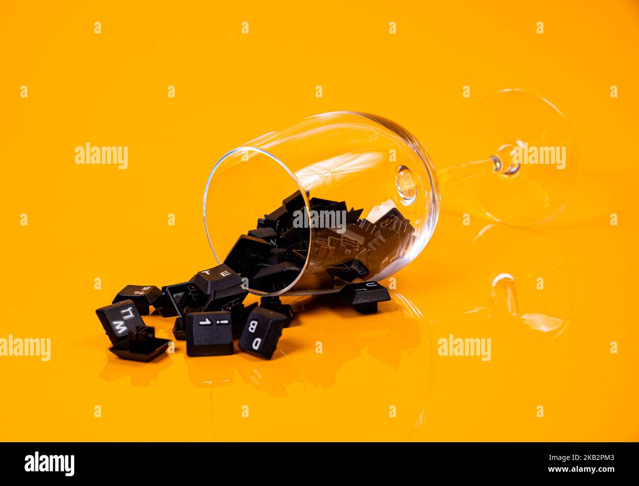 Tastatur-Taste in Glas in Eimer auf orangefarbenem Hintergrund isoliert Hacker Stockfoto