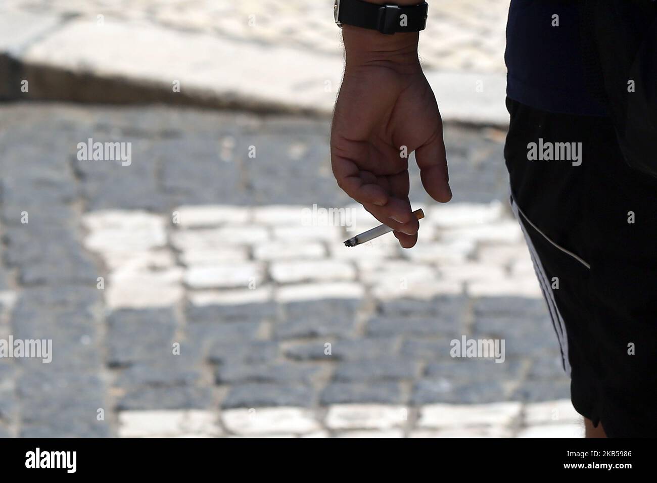 Ein Raucherin hält am 4. September 2019 in Lissabon, Portugal, eine Zigarette in der Kippe. Das Gesetz, das Maßnahmen zur Sammlung und Behandlung von Tabakabfällen genehmigt und mit Geldstrafen zwischen 25 und 250 Euro bestraft, die Hinterteile auf die öffentliche Straße werfen, wurde am 3. September in Republic Diary veröffentlicht. Zigarettenkippen, Zigarren oder andere Zigaretten, die Tabakprodukte enthalten, werden ab heute als fester Stadtabfall assimiliert, und ihre Entsorgung im öffentlichen Raum ist daher verboten. (Foto von Pedro FiÃºza/NurPhoto) Stockfoto
