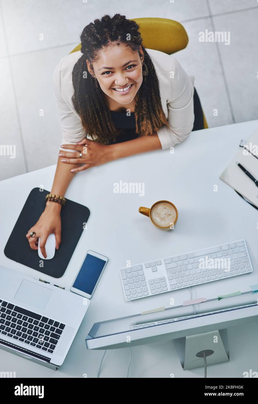 Ich bin nach oben. Hochwinkelporträt einer attraktiven jungen Geschäftsfrau, die an ihrem Schreibtisch im Büro arbeitet. Stockfoto