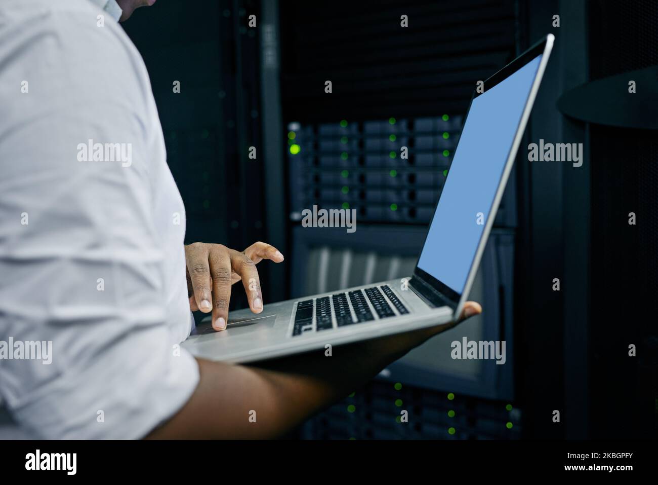 Moderne Tools für einen modernen IT-Techniker. Ein IT-Techniker, der einen Laptop verwendet, während er in einem Rechenzentrum arbeitet. Stockfoto
