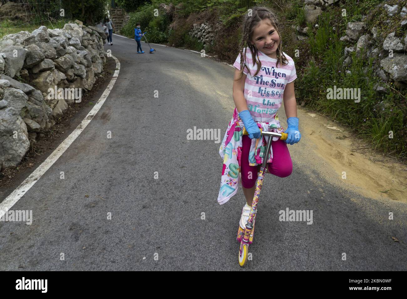 Una Niña juega con su patinete durante el primer dia de vuelta a dejar salir a los niños a la calle durante la cuarentena obligatoria decretada por el gobierno a consecuencia del coronavirus (Covid-19) en España (Foto: Joaquin Gomez Sastre/NurPhoto) Stockfoto