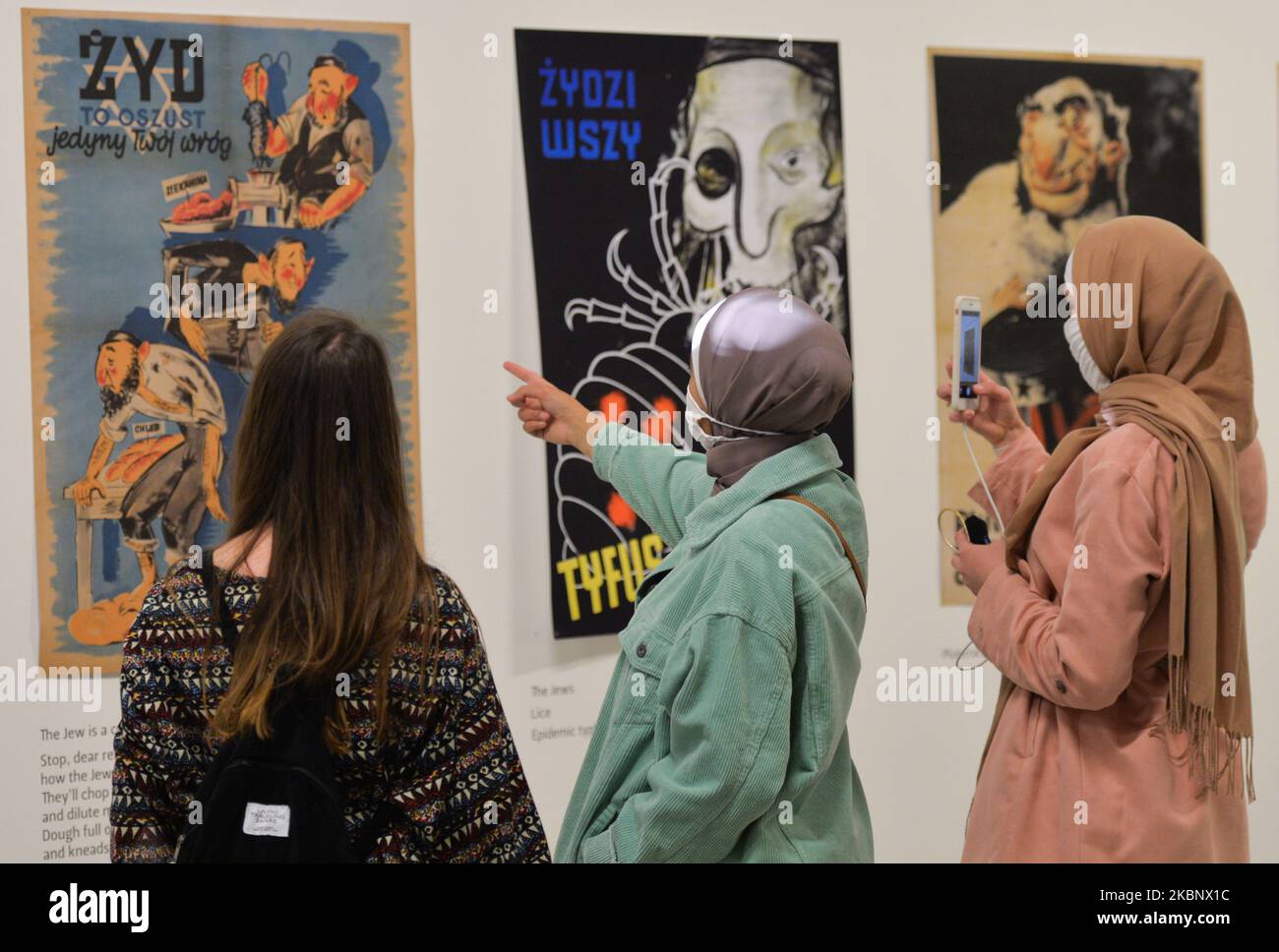 Die Besucher sehen sich antisemitische Nazi-Plakate an, die an Polen gerichtet sind, die Teil des Zweiten Weltkriegs – Drama, Symbol, Trauma-Ausstellung im Museum für zeitgenössische Kunst MOCAK in Krakau sind. Am 16. Mai 2020 in Krakau, Polen. (Foto von Artur Widak/NurPhoto) Stockfoto