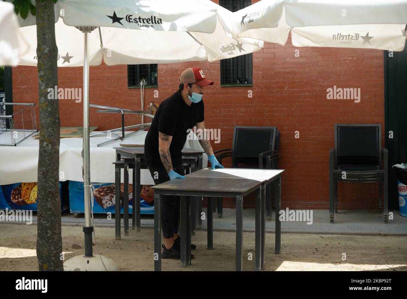 Ein Kellner desinfiziert am 25. Mai eine Tischfläche auf der Außenterrasse eines Cafés in Madrid, Spanien. Heute ist der erste Tag von Madrid in der Phase 1 der Enteskalation der Haft, können Menschen auf Terrassen und Terrassen gehen und beginnen, mit Gruppen von mehr als 10 Personen, Parque del Retiro, Madrid zu bleiben. (Foto von Jon Imanol Reino/NurPhoto) Stockfoto