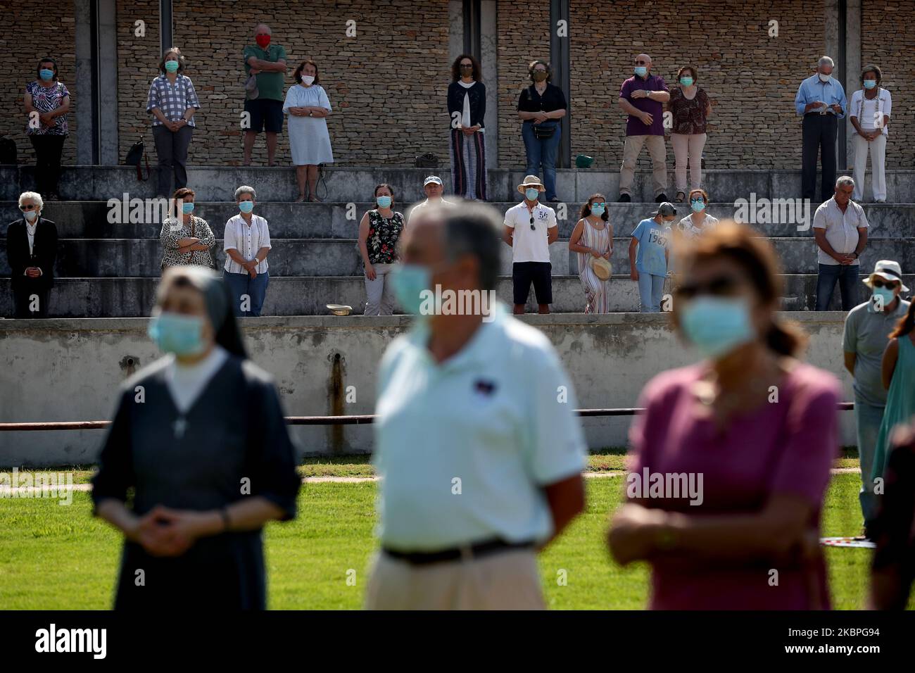 Faithfuls mit Gesichtsmasken beobachten soziale Distanzierungen, während sie an einer Open-Air-Messe teilnehmen, die von Pfarrer Nuno Coelho am 31. Mai 2020 im Hippodrom in Cascais, Portugal, inmitten der COVID-19-Pandemie gefeiert wird. Neue Regeln für die Gläubigen und Anpassungen der Kulte wurden von der katholischen Kirche angenommen, um die Kirchen wieder zu öffnen. (Foto von Pedro FiÃºza/NurPhoto) Stockfoto