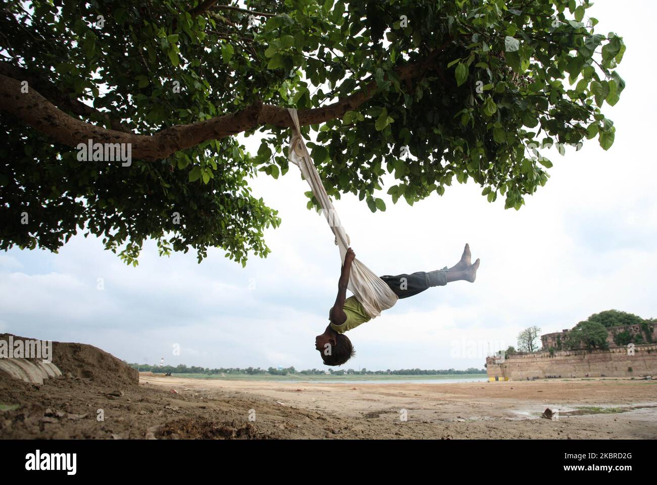 Ein Junge genießt es am 20. Juni 2020, am Ufer des Yamuna-Flusses in Allahabad, Indien, Seil zu schwingen. (Foto von Ritesh Shukla/NurPhoto) Stockfoto