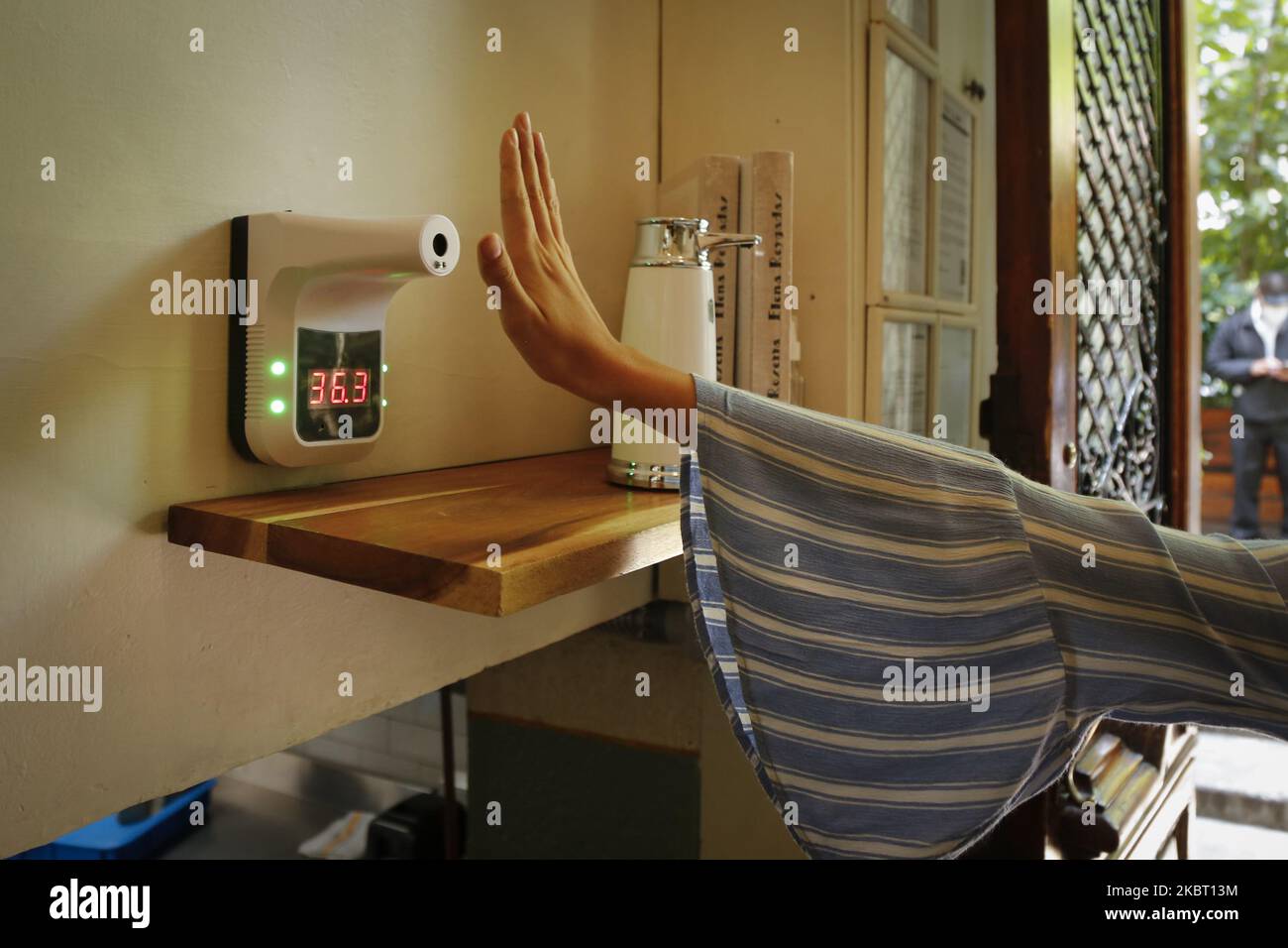 Eine Kundin fegt ihre Hand über ein Digitalthermometer, bevor sie am 01. Juli 2020 in Mexiko-Stadt, Mexiko, ein Restaurant betreten wird. Heute begann die Wiedereröffnung von Lebensmittelrestaurants in Mexiko-Stadt mit einer Kapazität von 30% mit strengen hygienischen Maßnahmen. (Foto von Guillermo Gutiérrez/NurPhoto) Stockfoto