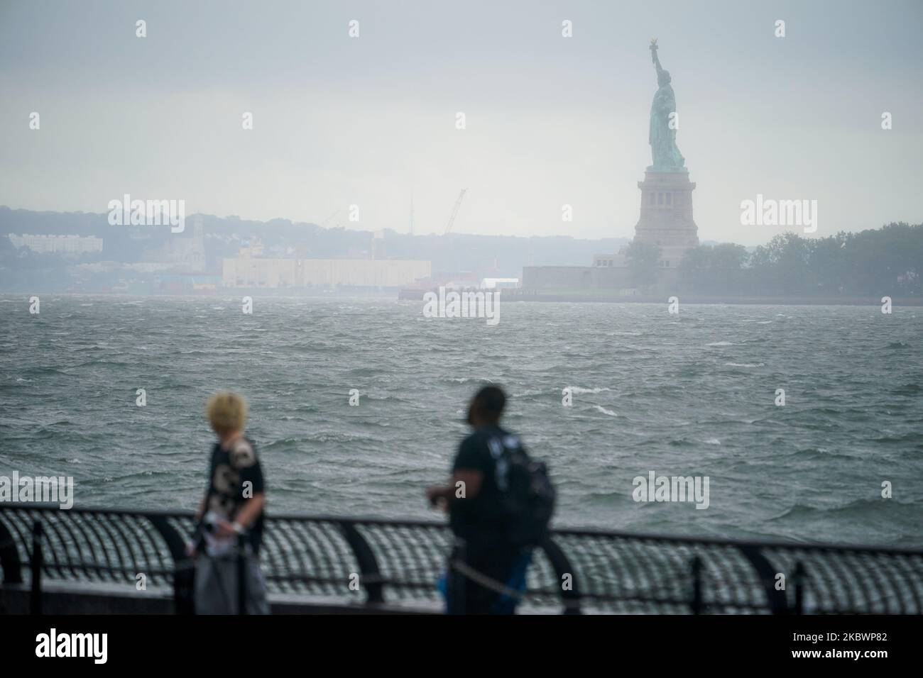 Raue Gewässer sind mit der Freiheitsstatue im Hintergrund zu sehen, während der tropische Sturm Isaias am 04. August 2020 in New York City auf dem Nordosten niedergeht. Der Sturm, der von einem Hurrikan herabgestuft wurde, wird in der Region New York City voraussichtlich 2 bis 4 Zoll Regen mit einer maximalen Windstärke von 40 bis 60 MPH bringen. (Foto von John Nacion/NurPhoto) Stockfoto